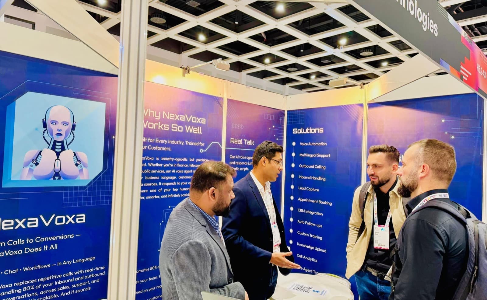 The team talking through NexaVoxa with visitors at the stand
