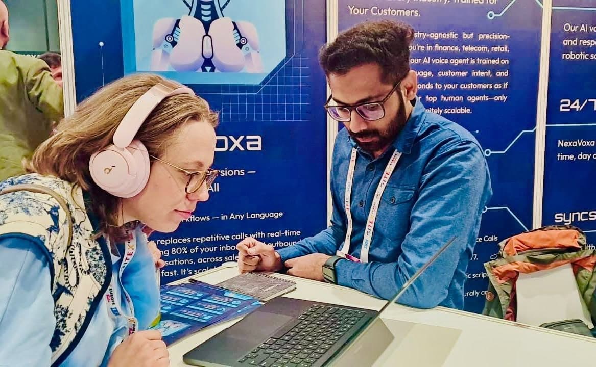 A visitor trying the NexaVoxa voice agent on a headset at the stand