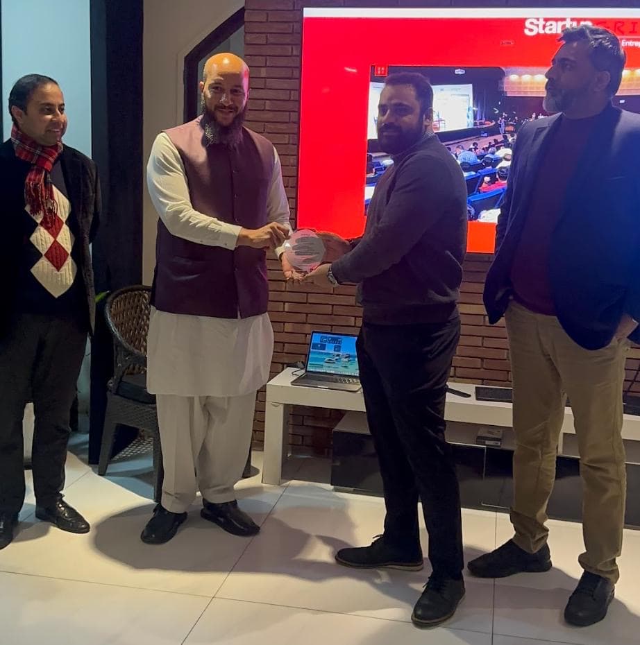 William Campbell of the US Consulate Lahore presents Hamza Israr with a token of gratitude